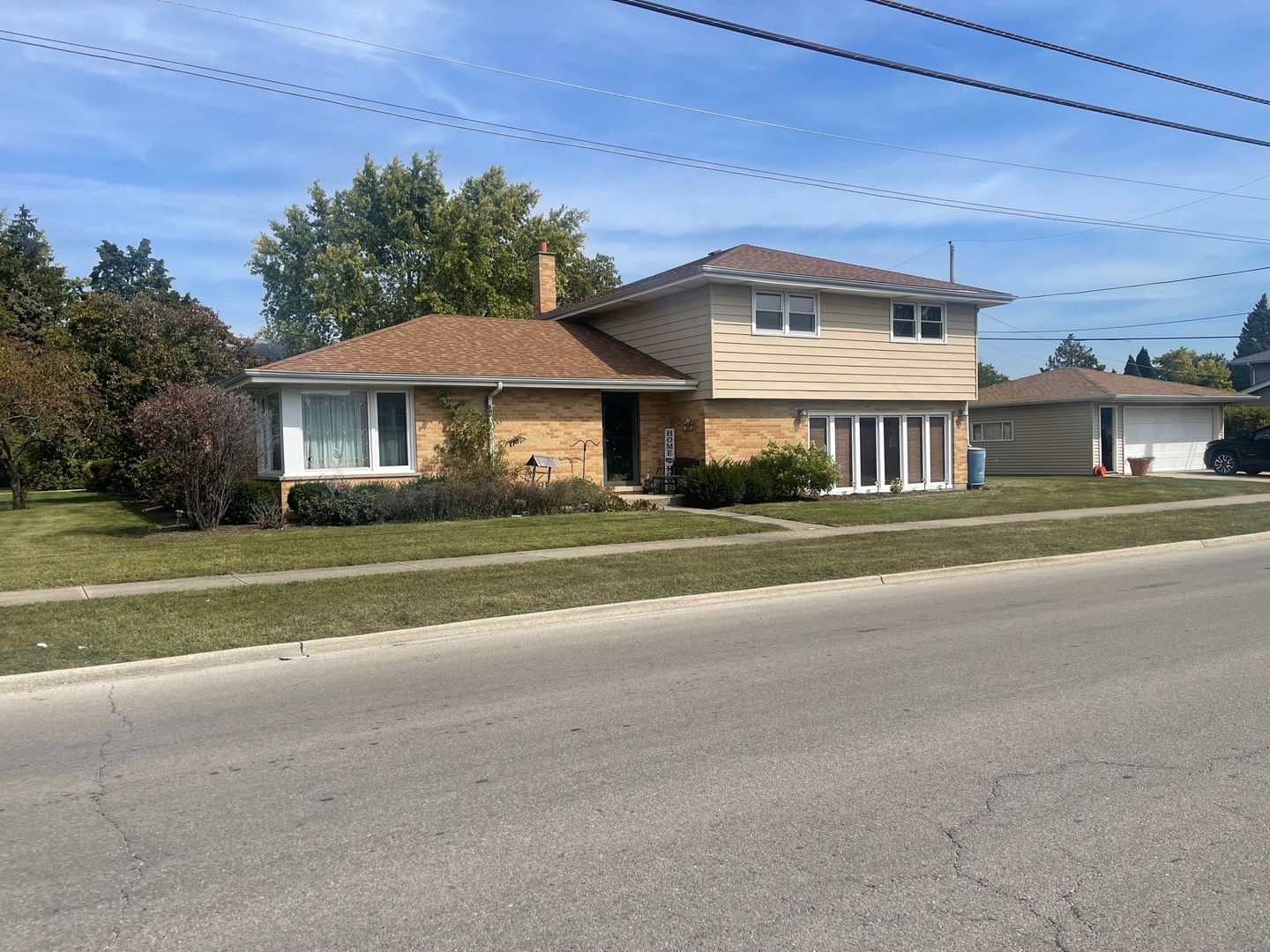 a front view of a house with a garden