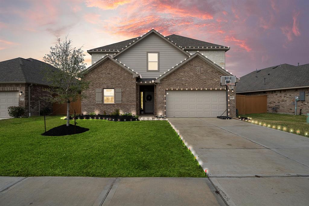 a front view of a house with a yard and garage