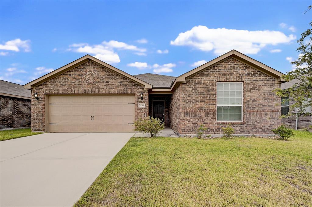 a front view of a house with yard and garage