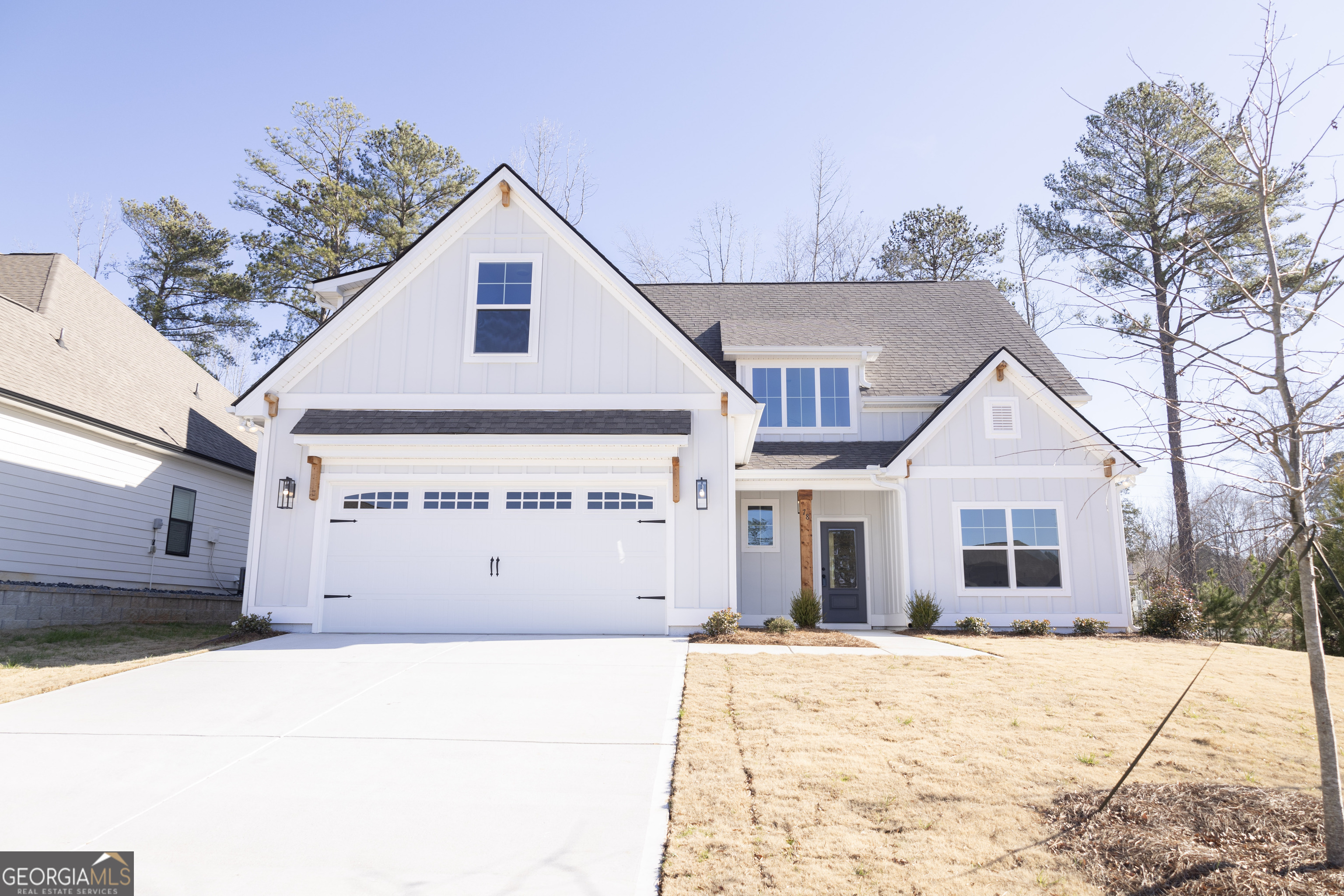 a view of a house with a yard covered in snow