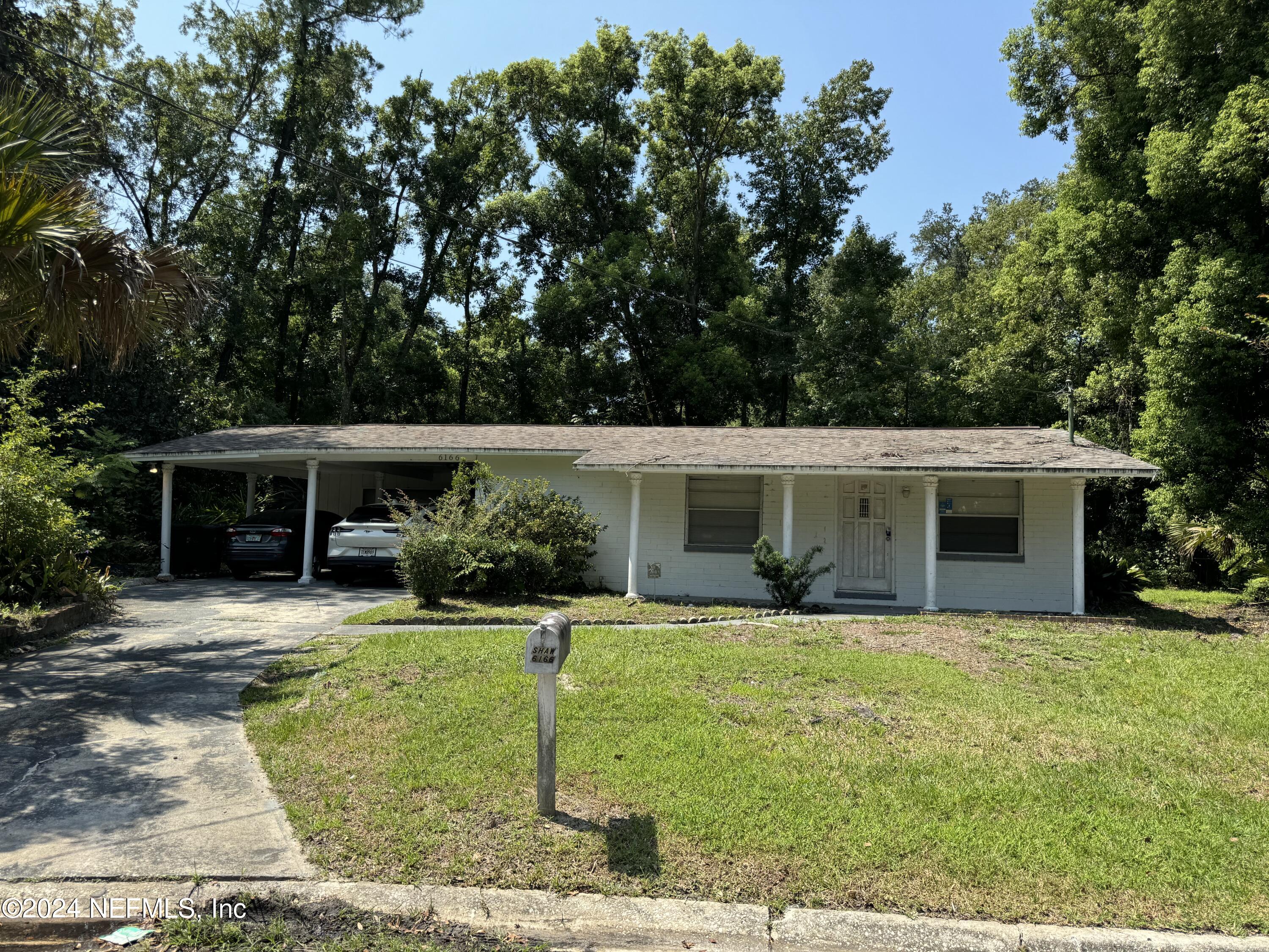 a front view of house with yard and trees