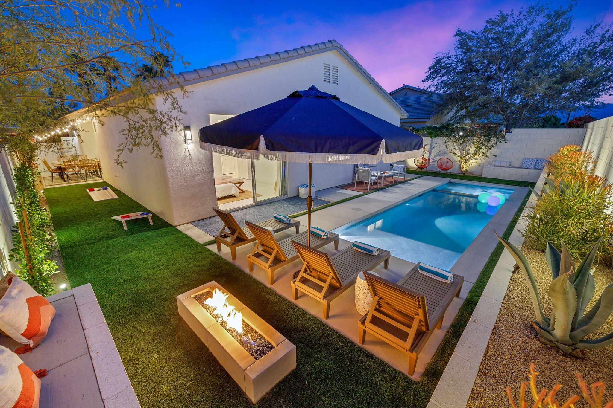 an aerial view of a house with pool patio and fire pit