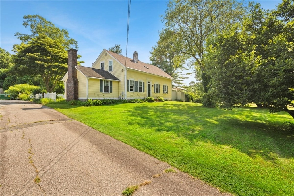 a front view of house with yard and green space