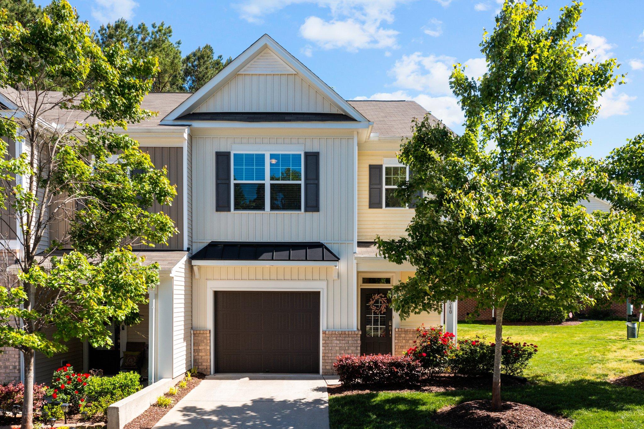 a front view of a house with a yard and garage