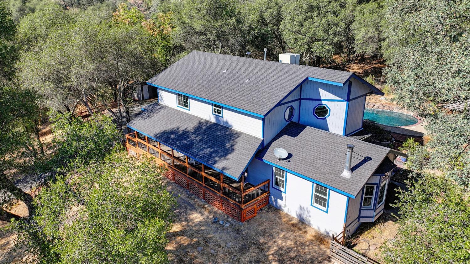 an aerial view of a house with a yard