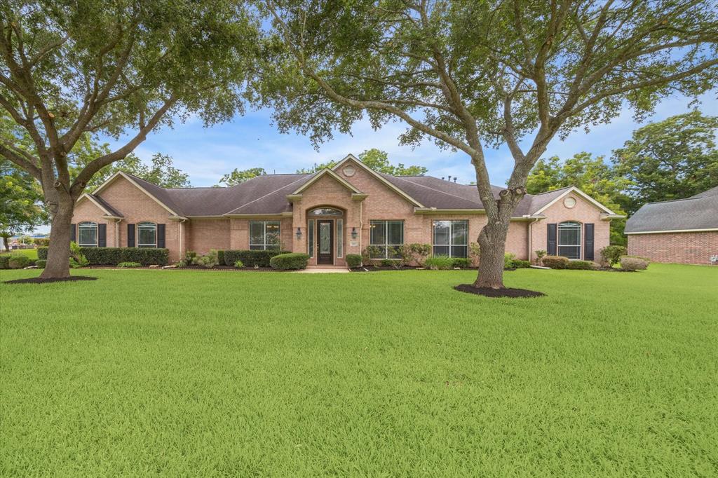 a front view of a house with a garden and yard