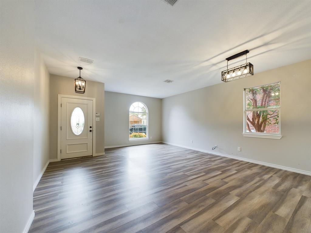 a view of a room with wooden floor