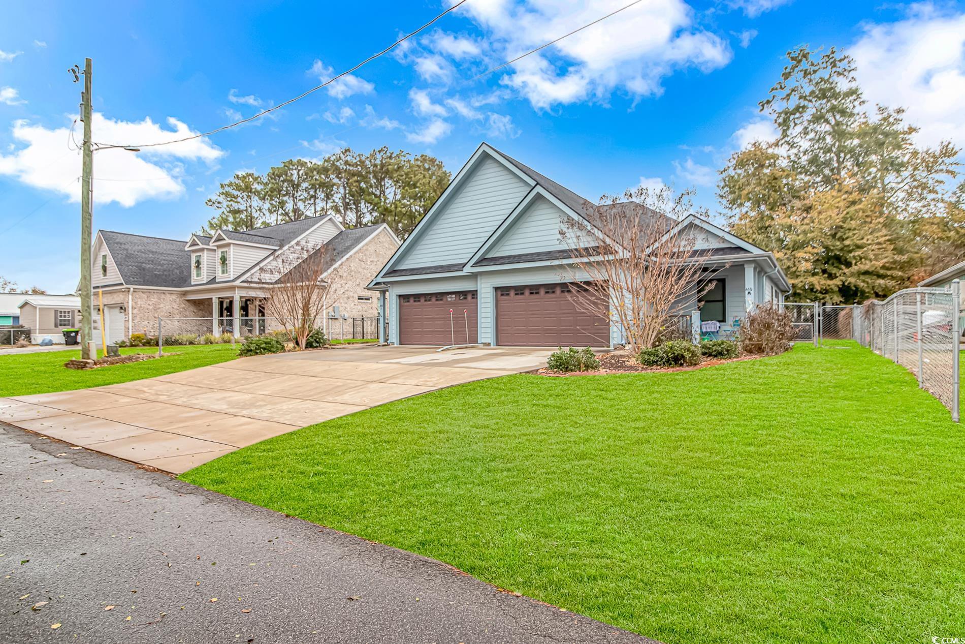 View of front of property featuring a garage and a