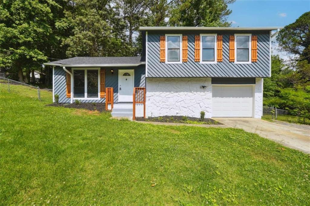 a front view of a house with a garden and porch