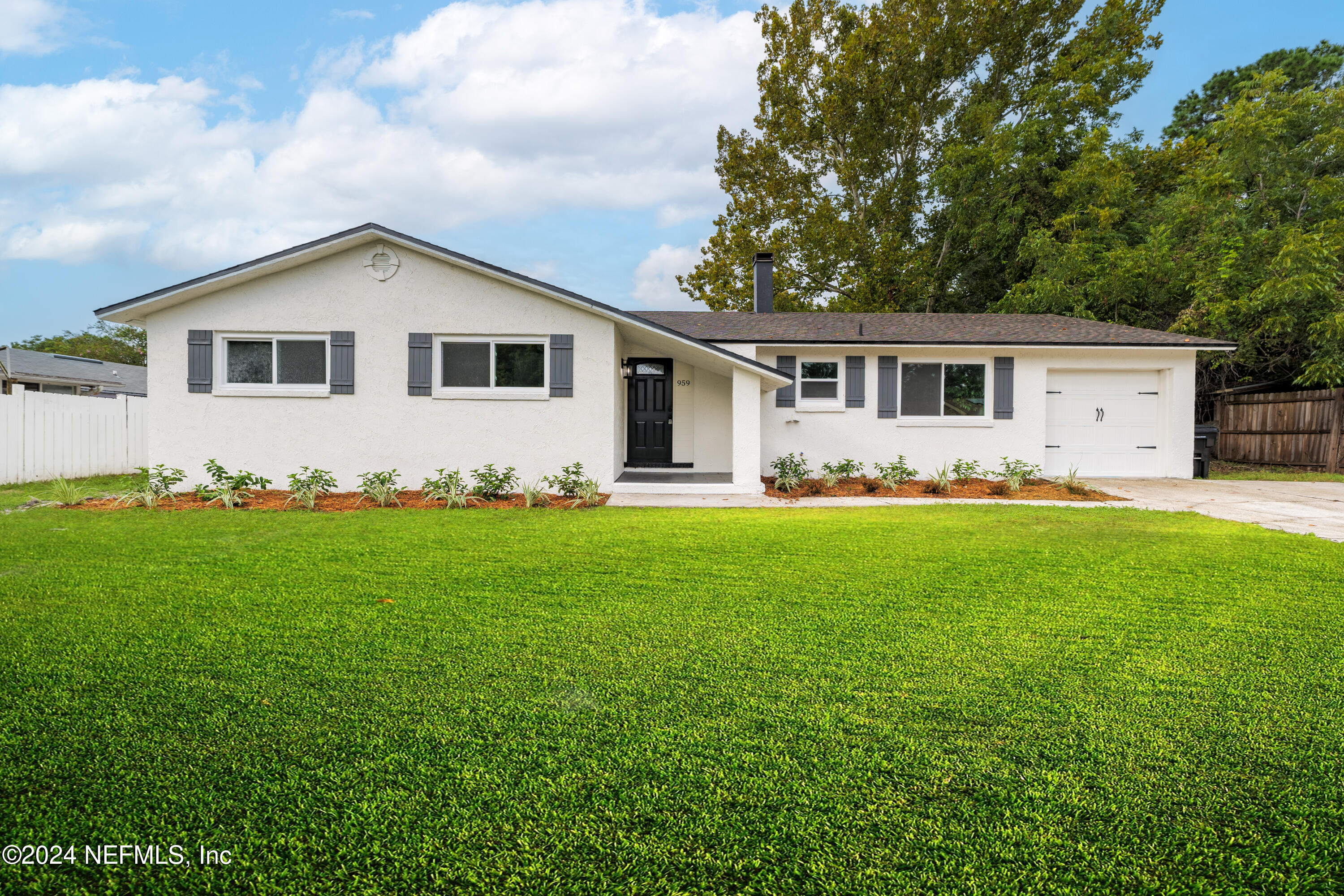 a front view of house with yard and green space