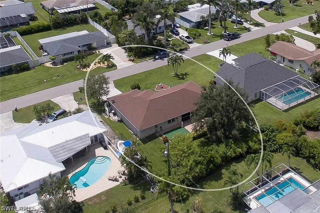 an aerial view of a house with garden space and street view