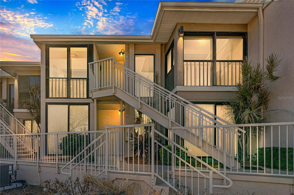 a view of staircase with railing and a large window