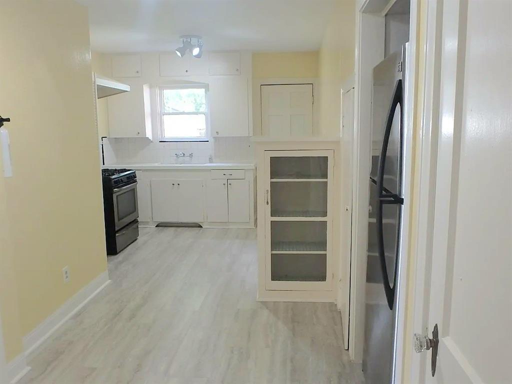 a view of a kitchen with a sink dishwasher and a refrigerator