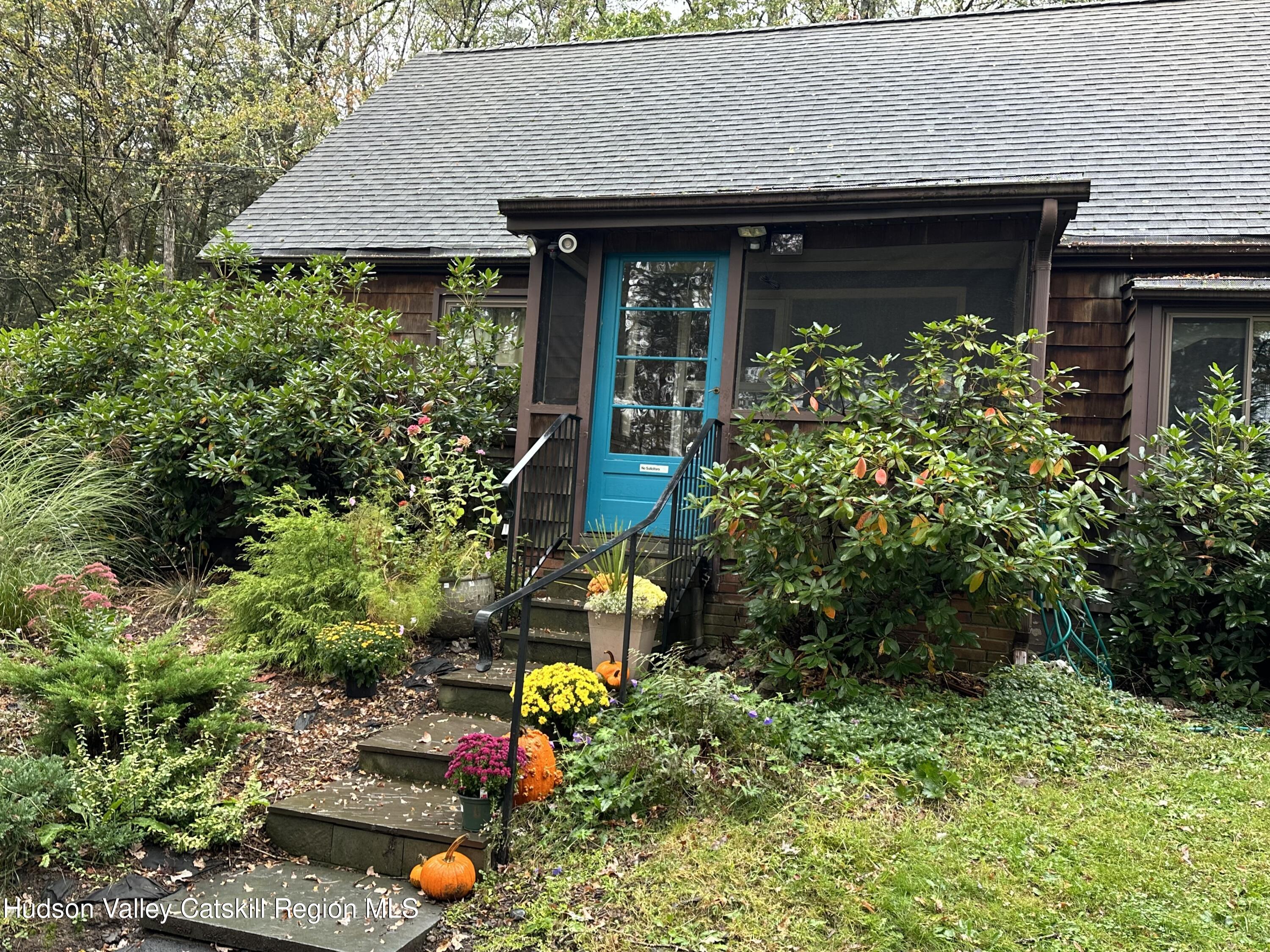 front view of a house with a tree