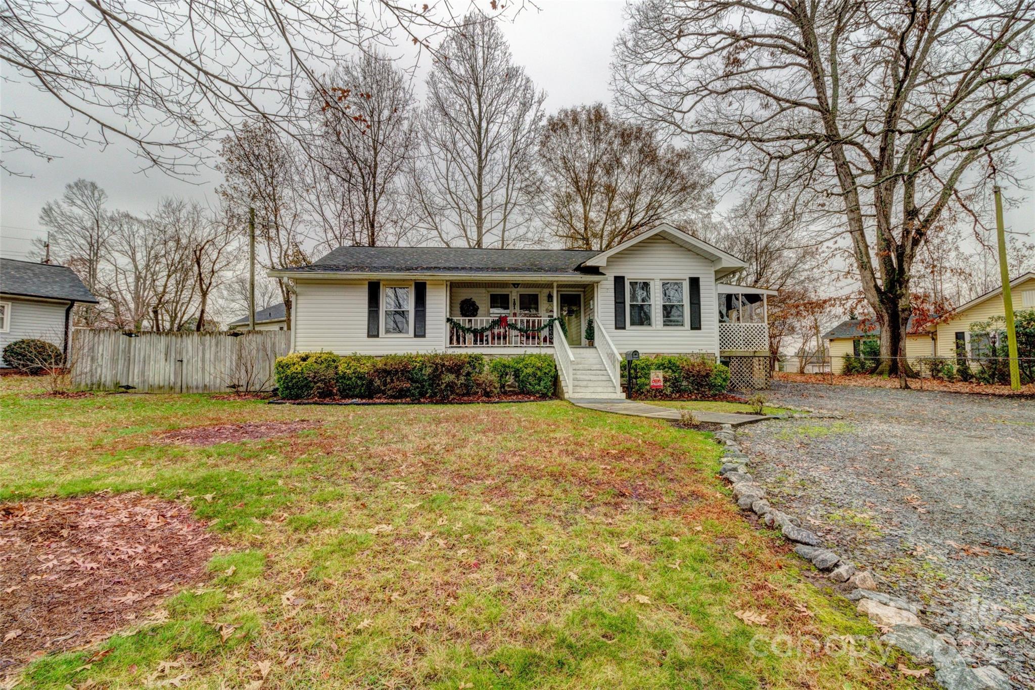 a front view of house with yard and trees around