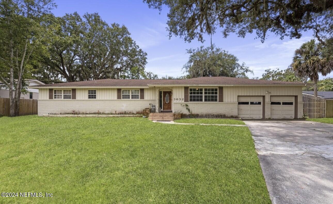 a front view of house with yard and green space