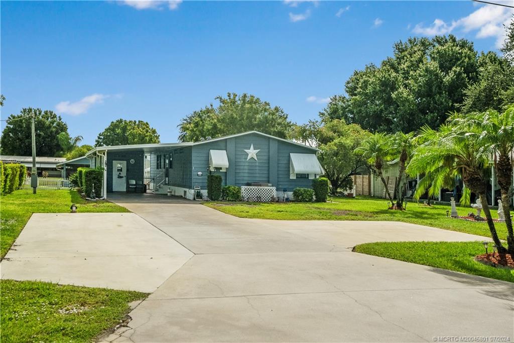 a front view of house with yard and green space