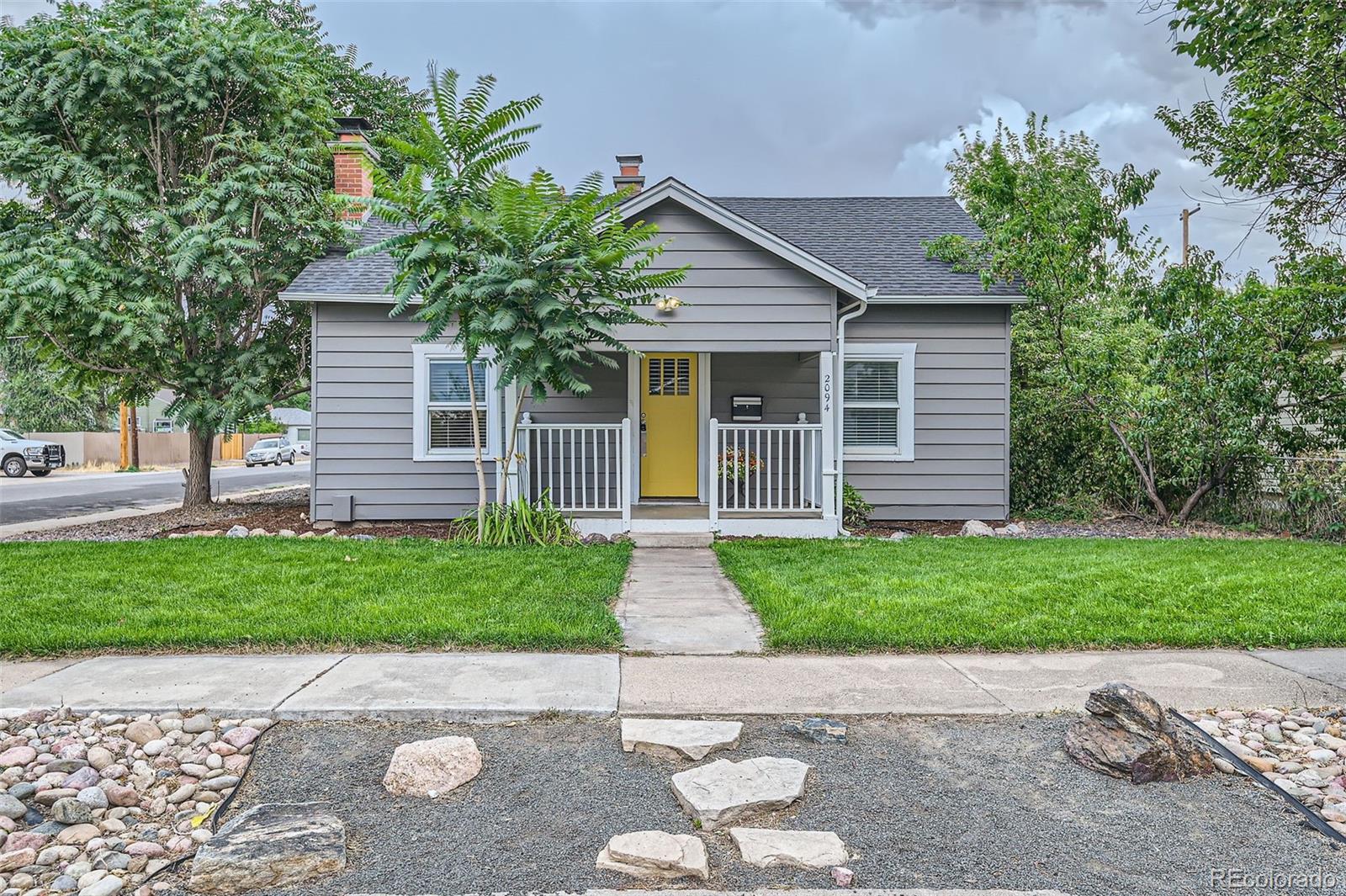 a front view of a house with a yard and a garage