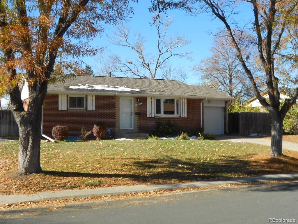 a front view of a house with a yard covered with snow