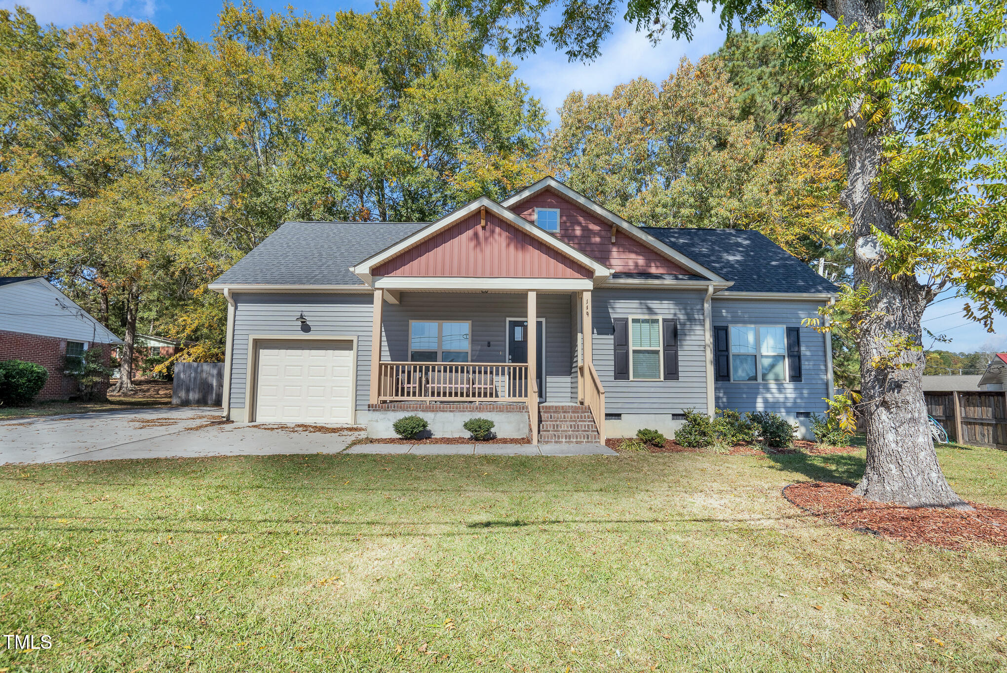 a front view of a house with a garden and yard