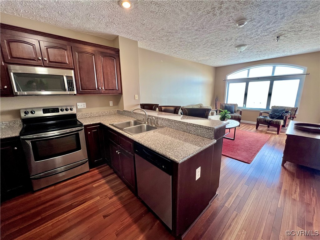 Kitchen with dark hardwood / wood-style flooring,