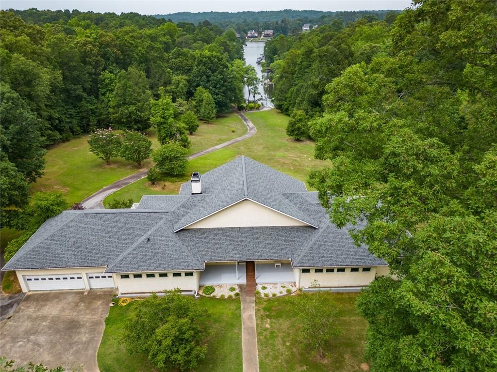 a aerial view of a house with a yard and lake view