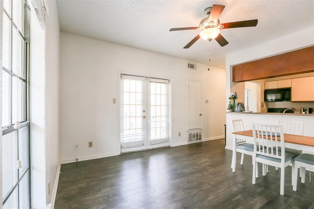 a view of a livingroom with furniture a ceiling fan and wooden floor