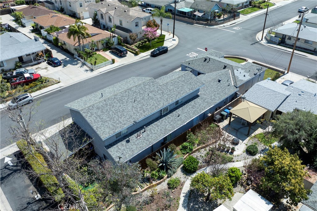 an aerial view of a house with a yard and wooden deck