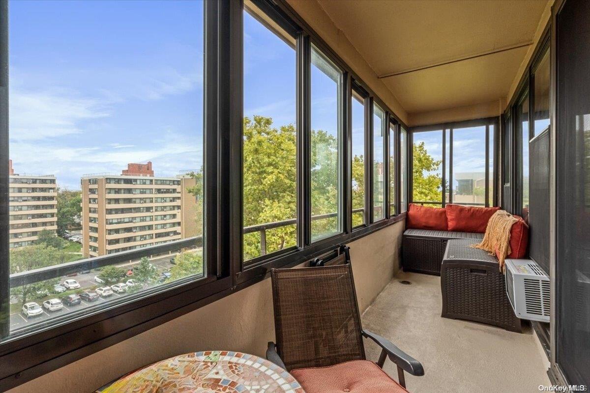 a living room with furniture and large windows