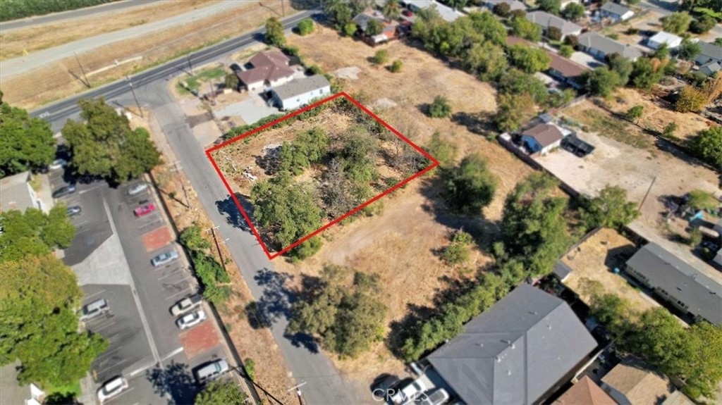 an aerial view of a house with a yard and lake view