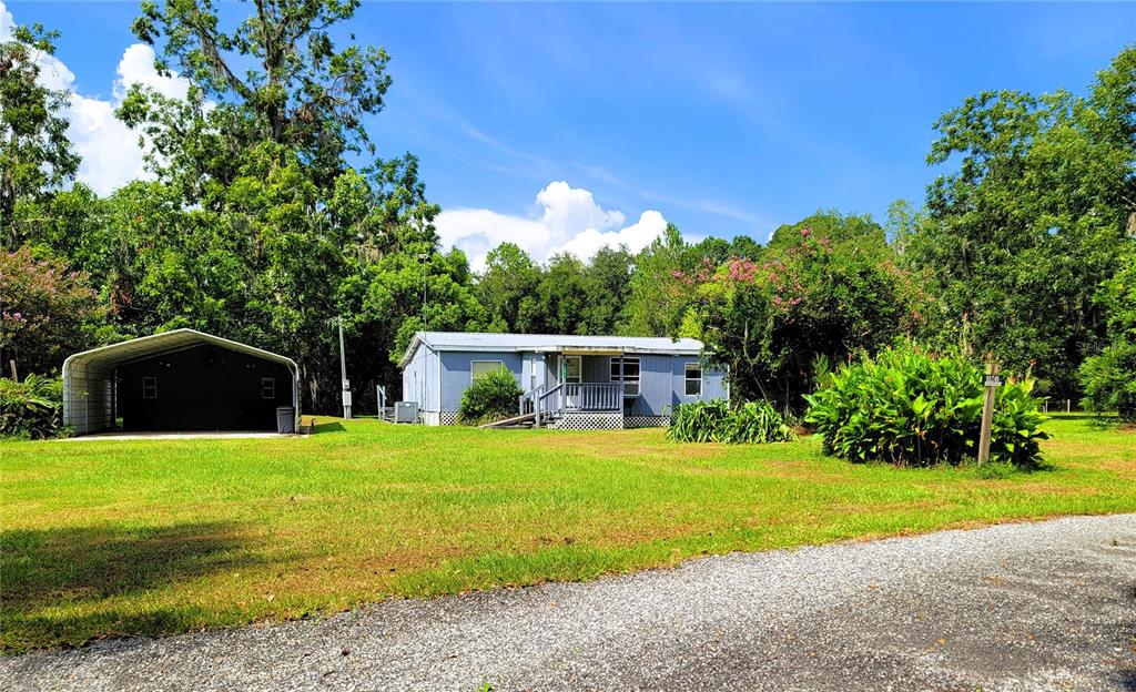 a front view of house with yard and green space