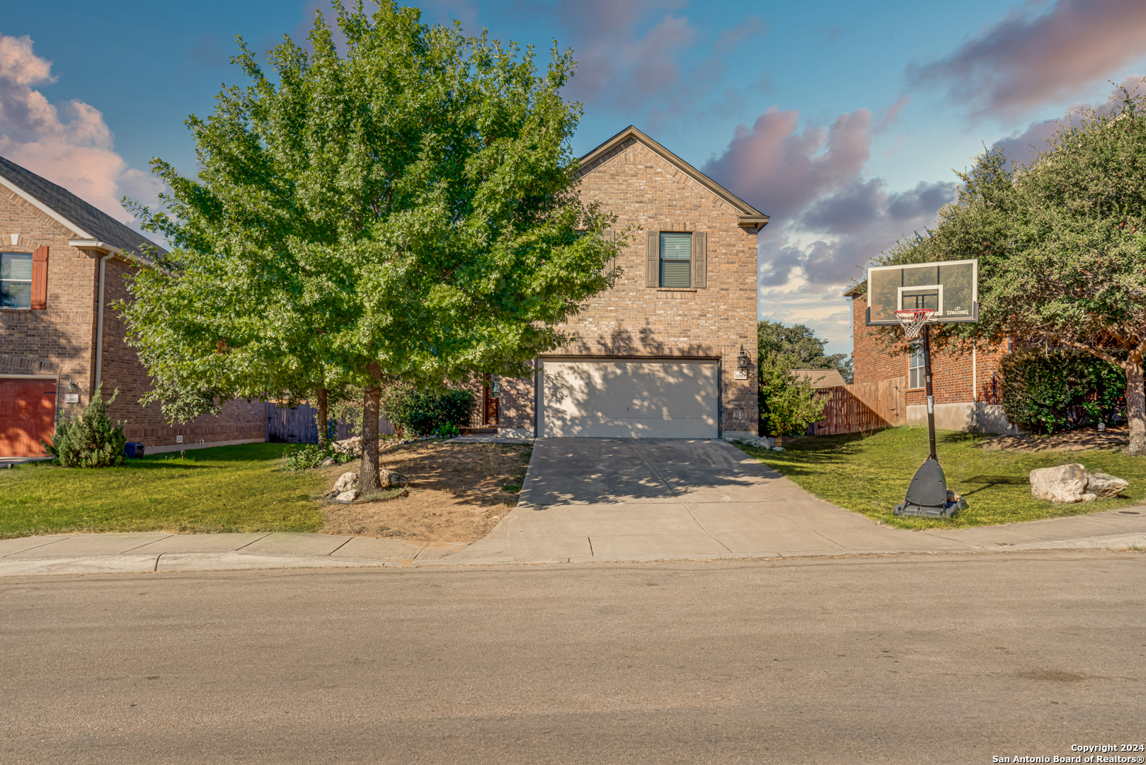 a view of a house with a yard and tree s