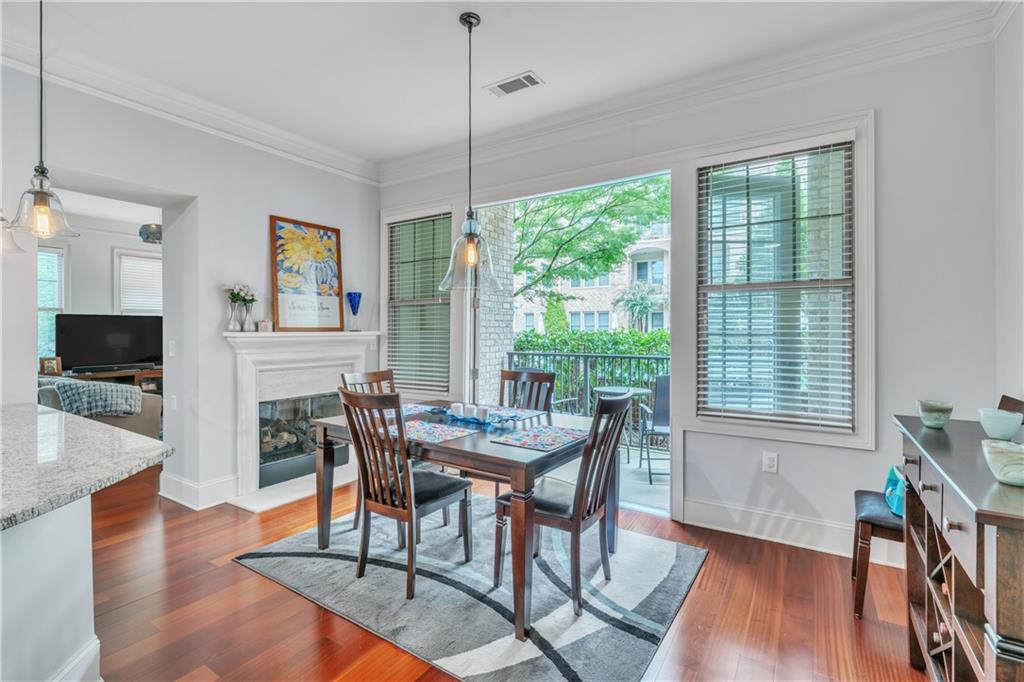 a view of a dining room with furniture window and wooden floor