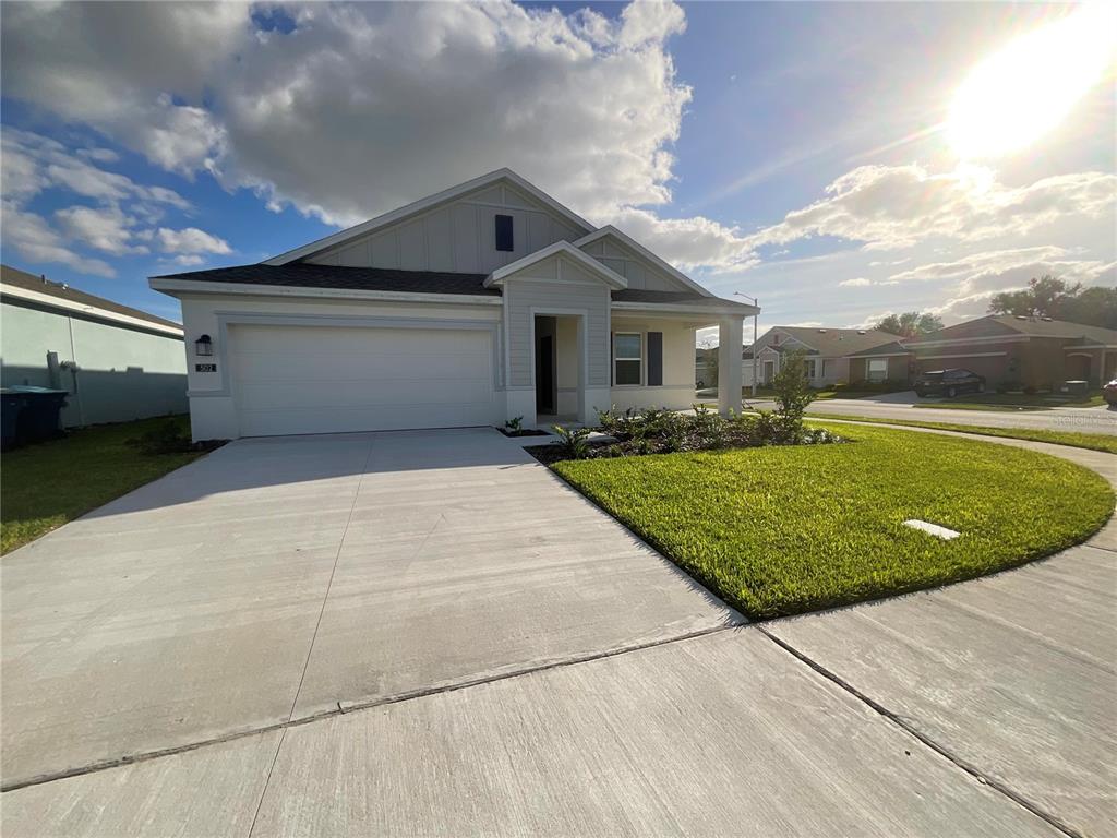 a front view of a house with a yard and garage