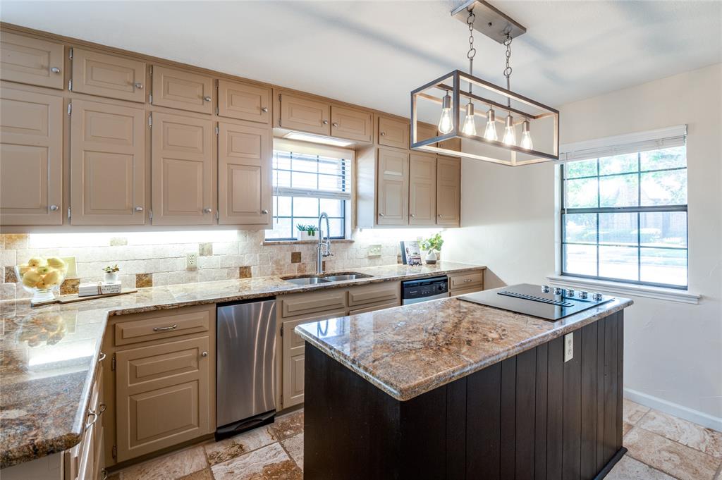 a kitchen with granite countertop cabinets sink and window