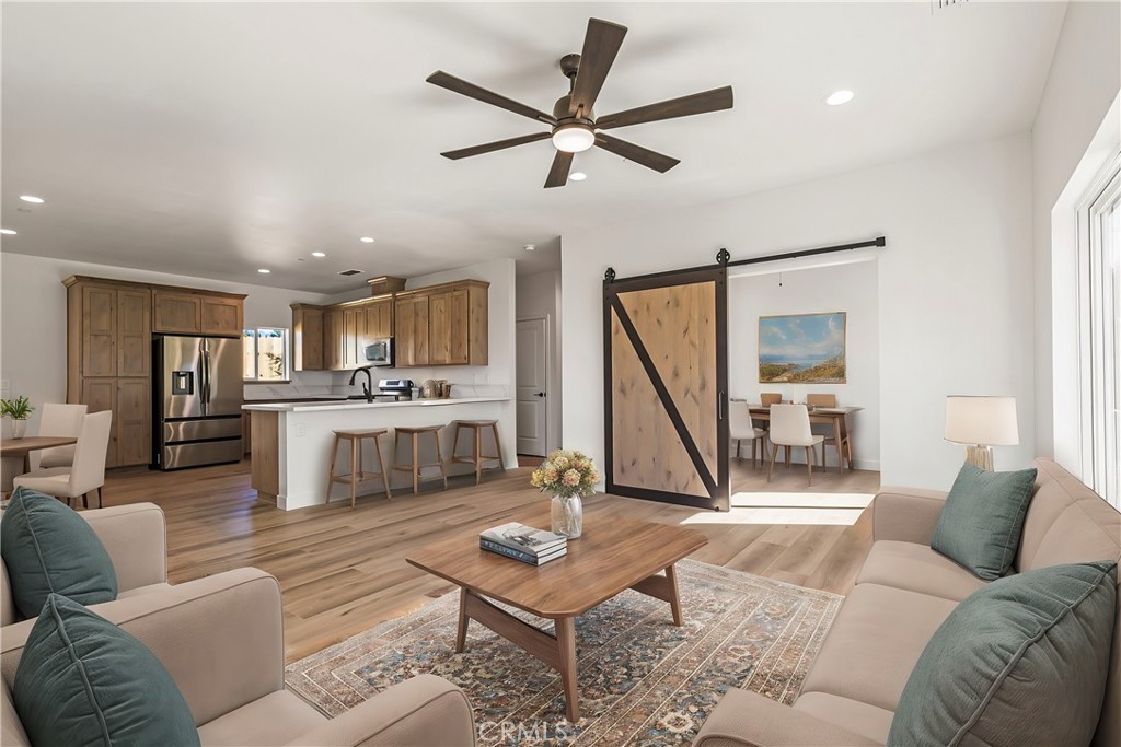 a living room with furniture and kitchen view