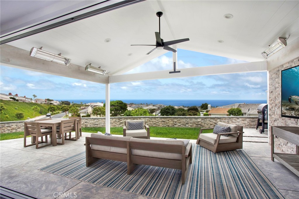 a view of a roof deck couches and city view