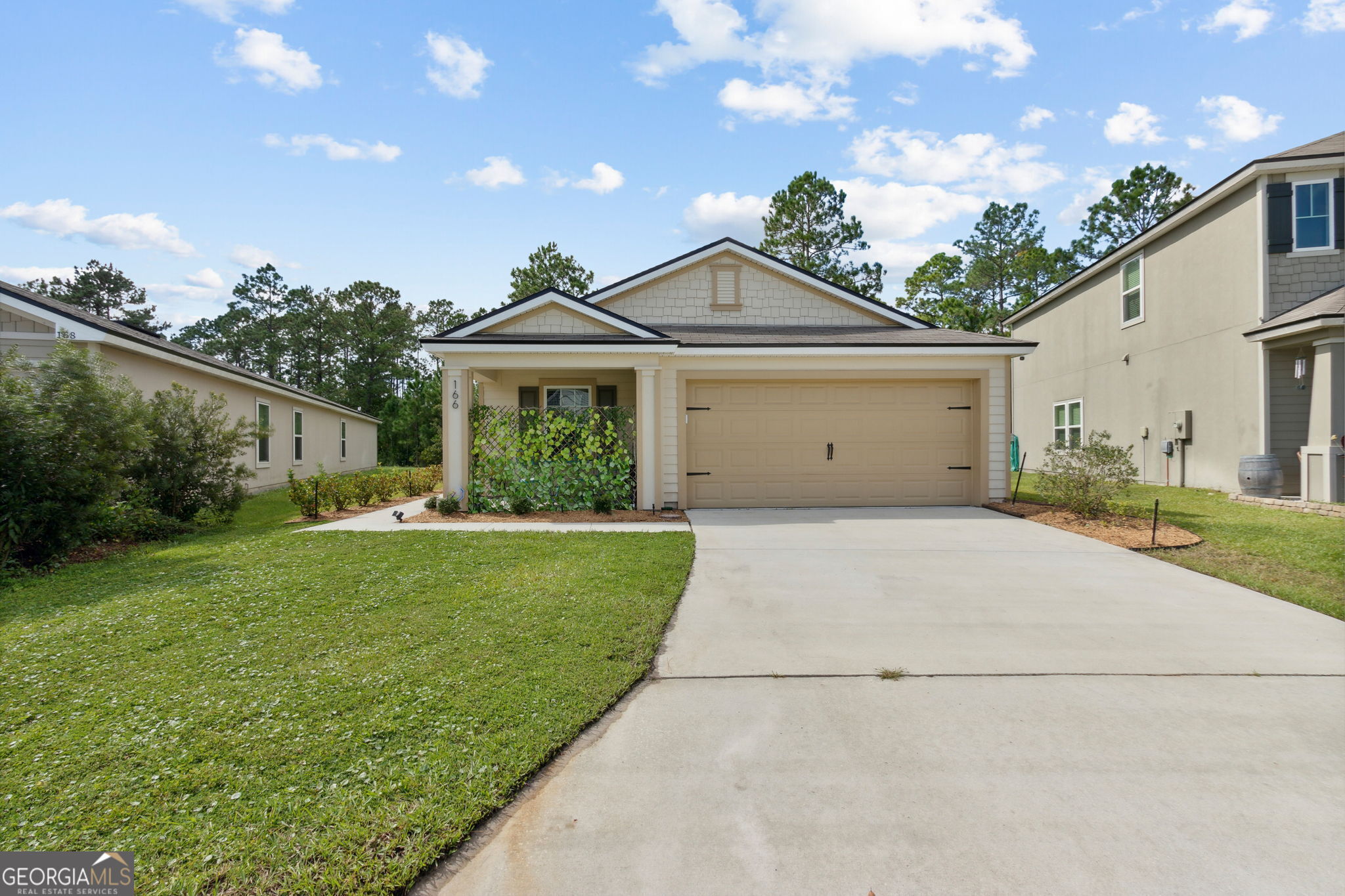 a front view of a house with a garden