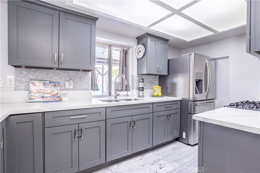 a kitchen with sink and cabinets