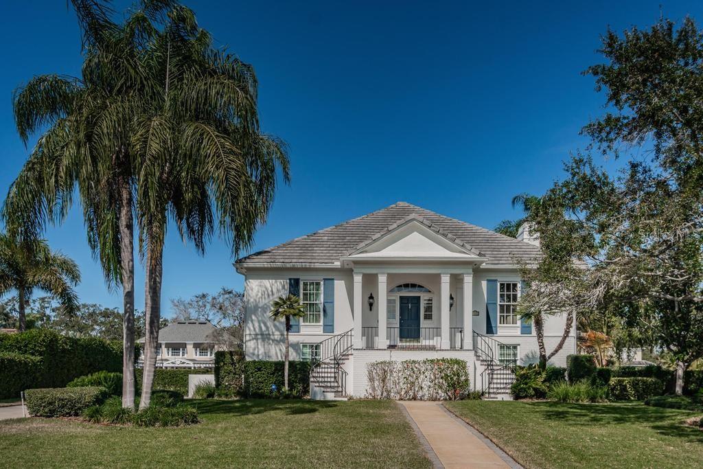 a front view of a house with a garden