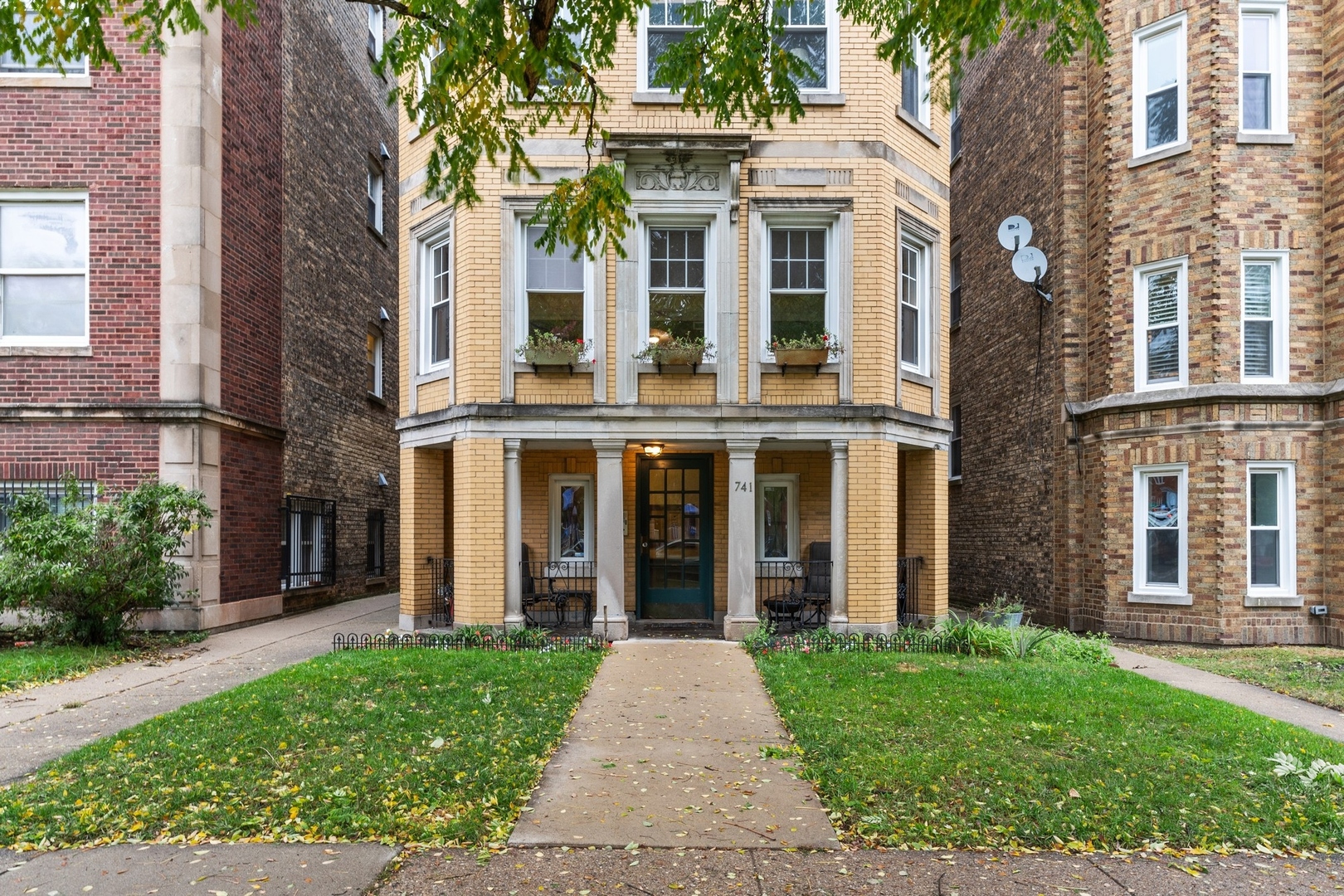 front view of a brick house with a yard