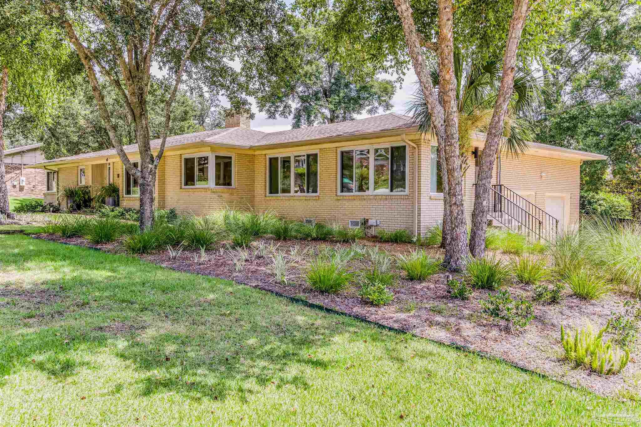 a front view of a house with garden