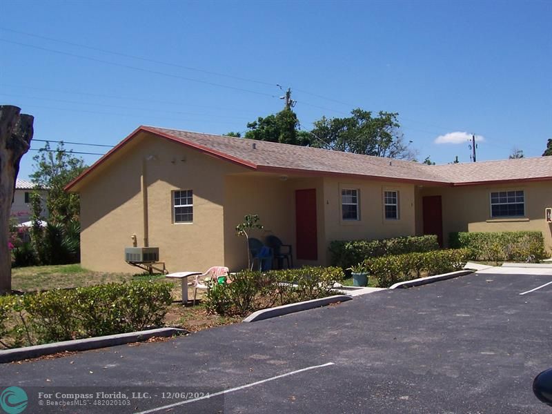 a front view of a house with a yard and outdoor seating