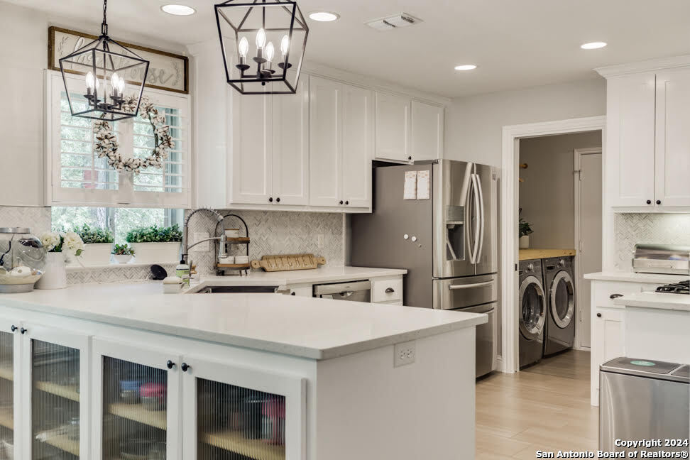 a kitchen with stainless steel appliances a refrigerator sink and stove