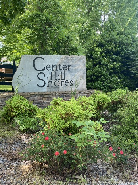 a view of sign board with green space