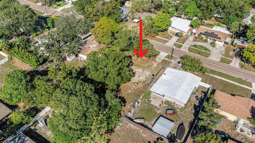 an aerial view of a house with a yard and garden