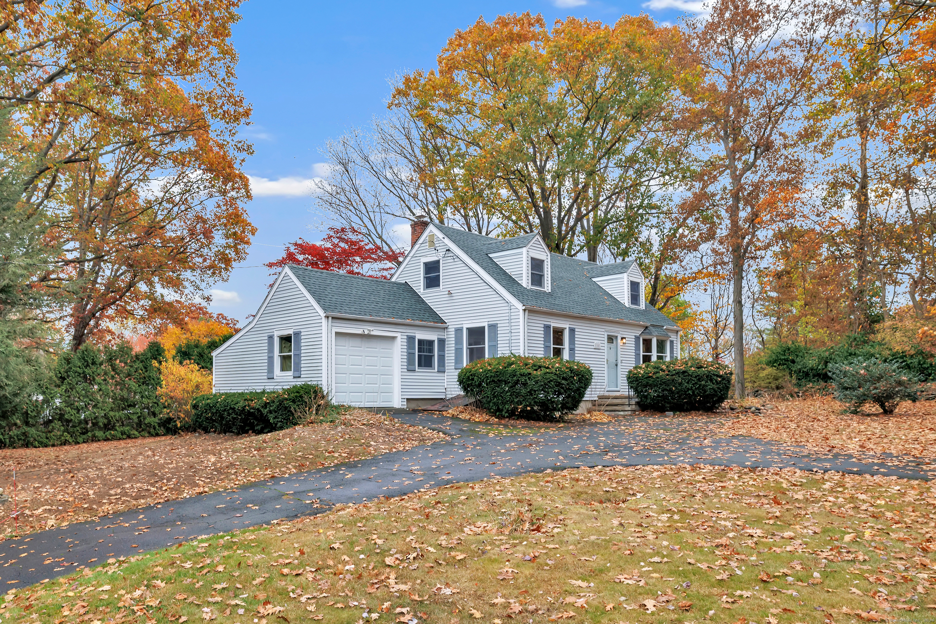 a front view of a house with a yard and potted plants