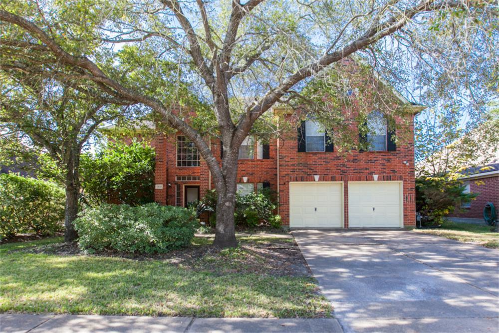 a view of a house with a tree in the yard