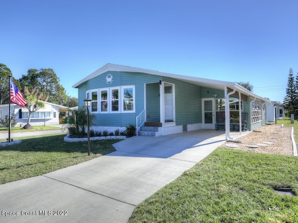 a front view of a house with a yard and porch