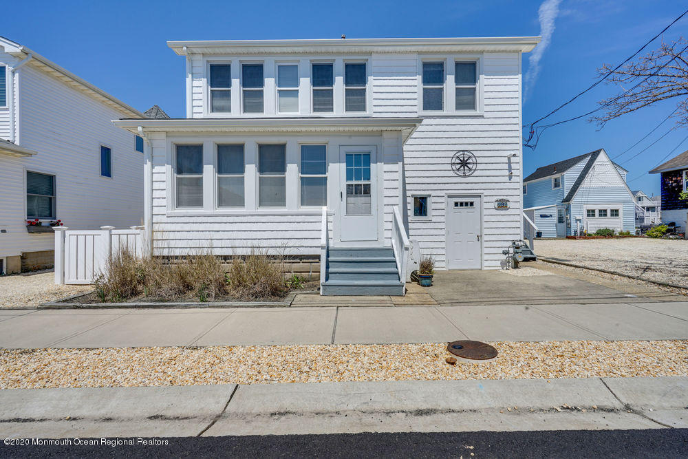 a front view of a house with a road